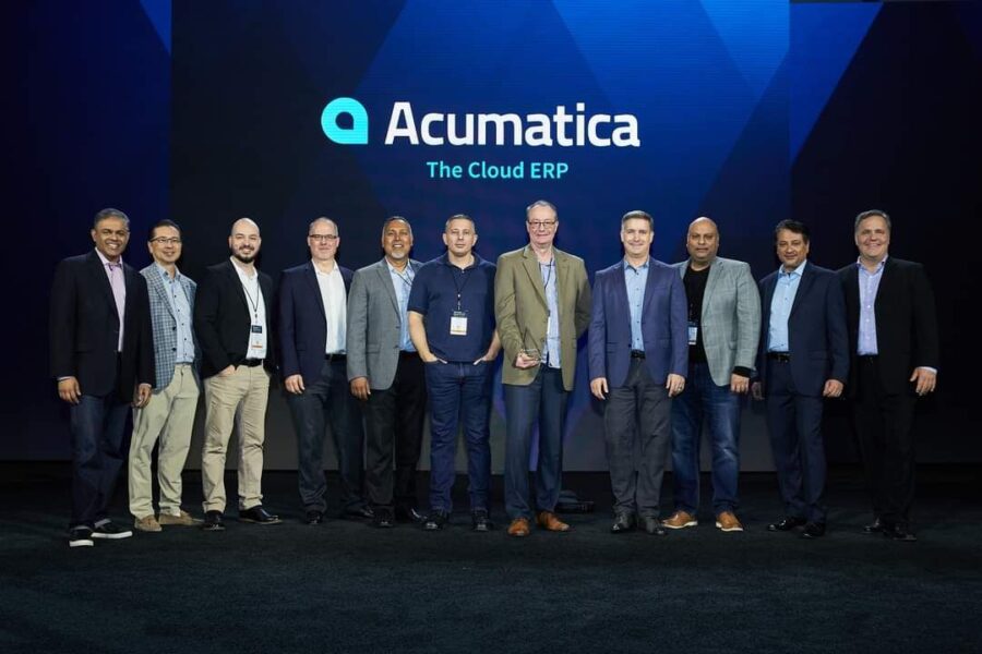 The Answer Company Team stands at the stage of Acumatica Summit 