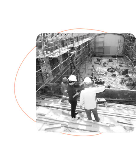Construction workers standing on worksite.